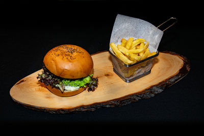 Close-up of cake on table against black background