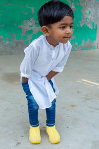 Portrait of cute boy standing outdoors