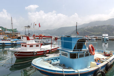 Boats moored in sea against sky