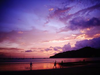 Scenic view of beach against cloudy colorful sky