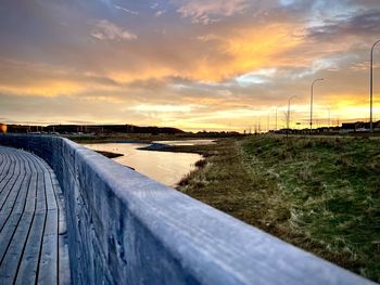 Scenic view of river against sky during sunset