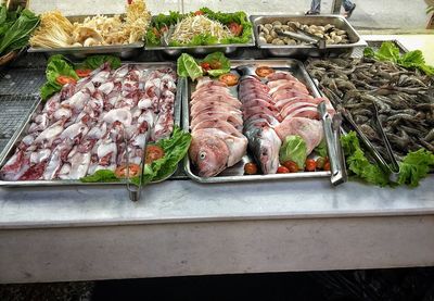 High angle view of fishes in trays on table