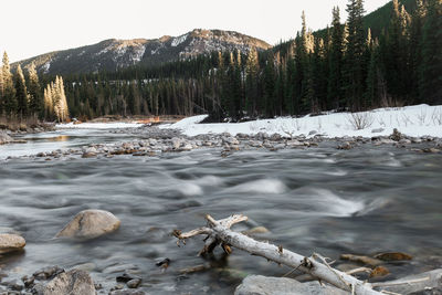 Scenic view of river against sky during winter