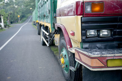 View of yellow car parked on road