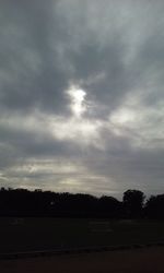 Scenic view of silhouette field against sky at dusk