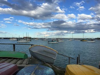 Boats moored in lake against sky