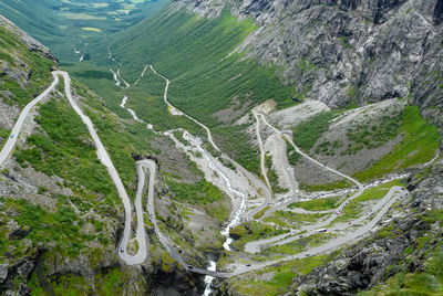 High angle view of winding road amidst mountains