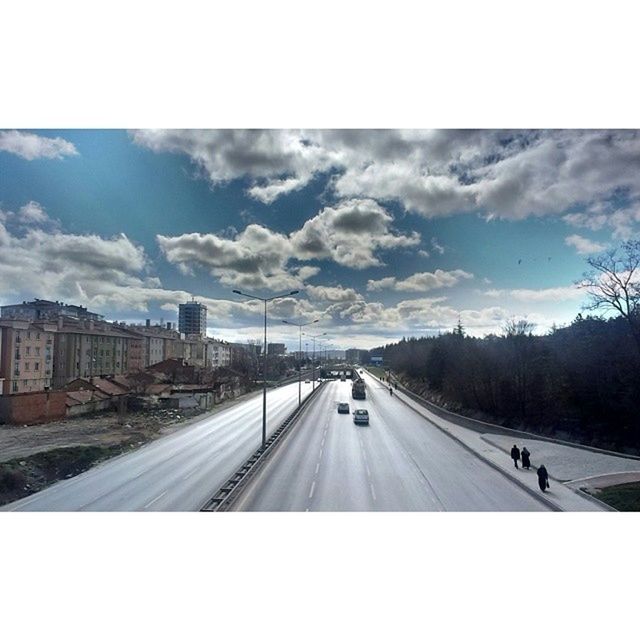 transfer print, sky, transportation, auto post production filter, cloud - sky, road, cloud, city, water, architecture, built structure, building exterior, day, car, road marking, mode of transport, river, high angle view, cloudy