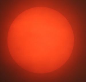 Close-up of moon against orange sky