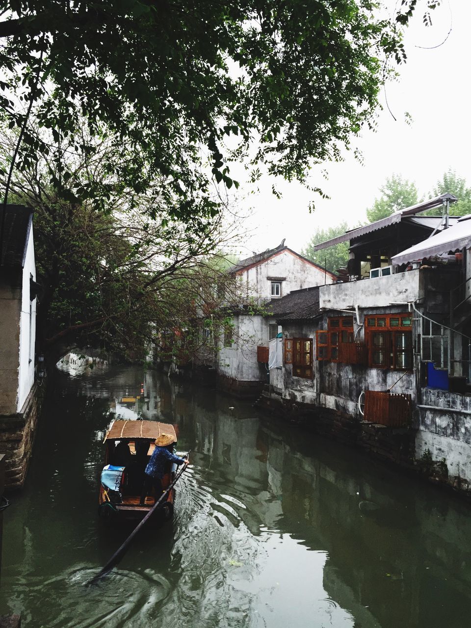 mode of transport, transportation, water, building exterior, nautical vessel, canal, tree, architecture, built structure, boat, land vehicle, reflection, car, moored, waterfront, house, river, day, residential structure