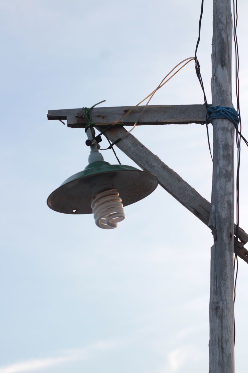 LOW ANGLE VIEW OF LIGHT BULB HANGING AGAINST SKY