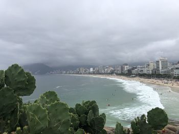 High angle view of sea and buildings against sky