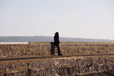 Full length of man standing on sea against sky