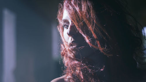 Close-up cinematic portrait of beautiful actress with wind in her red hair
