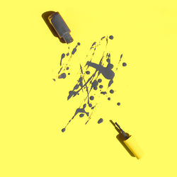 High angle view of bottles on yellow background