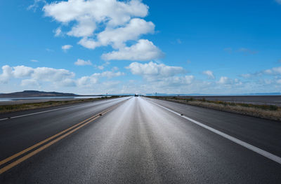 Empty road along countryside landscape