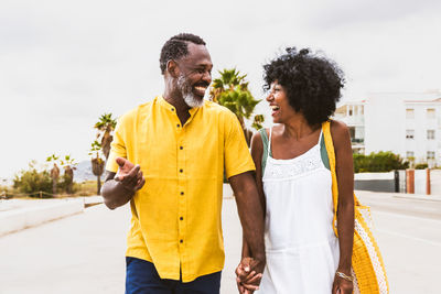 Portrait of senior couple standing against sky