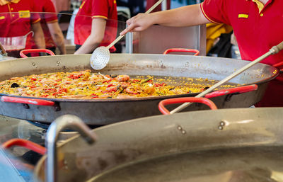 Midsection of man preparing food in large container