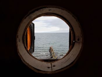 View of sea seen through window