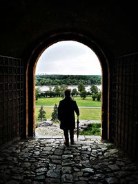 Rear view of man standing on the fortress, looking at the landscape. 