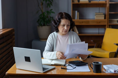 Young woman using laptop at home