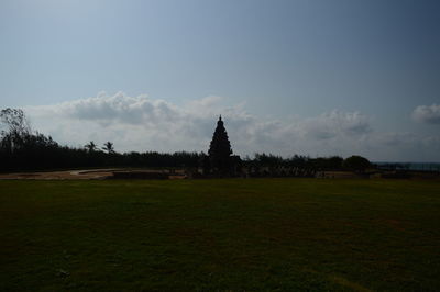 Built structure on field against sky