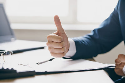 Midsection of man working on table