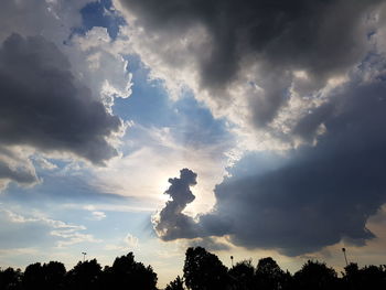 Low angle view of silhouette trees against sky