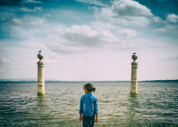 Rear view of man standing on lighthouse