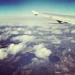 Cropped image of airplane wing over landscape
