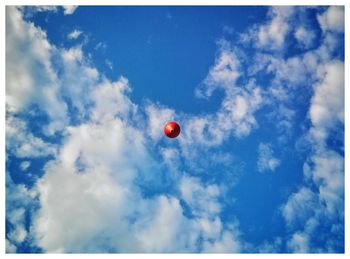 Low angle view of balloons against sky