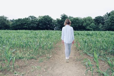 Rear view of girl standing on field