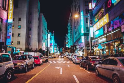 View of city street and buildings at night