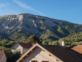 Houses on mountain against sky