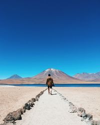 Rear view of man standing on desert