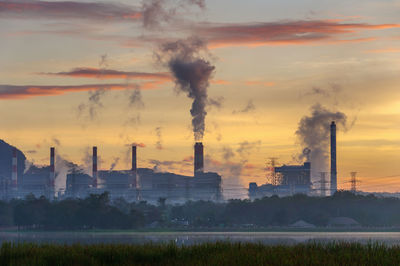 Coal power plant and steam from the flue in the morning.