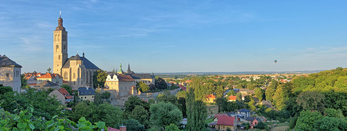 Panoramic view of trees and buildings against sky