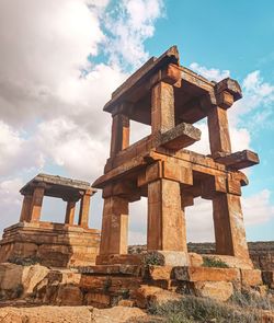 Low angle view of historical building against cloudy sky