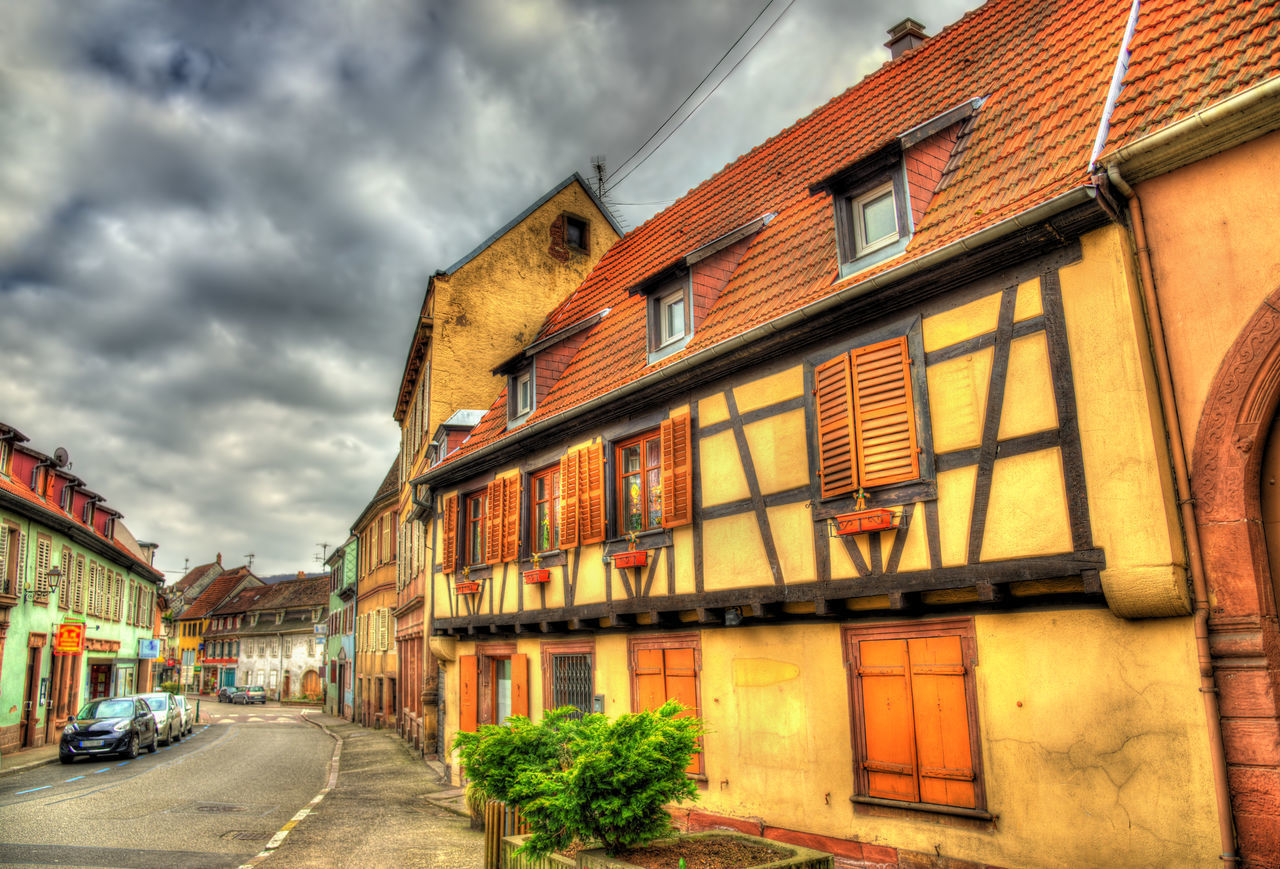 STREET AMIDST BUILDINGS AGAINST SKY