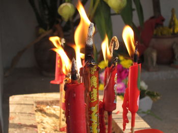 Close-up of red candles burning on table