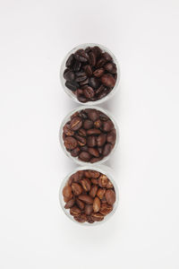 Directly above shot of coffee beans against white background