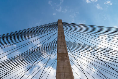 Low angle view of bridge against cloudy sky