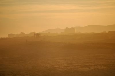 Scenic view of landscape against sky during sunset