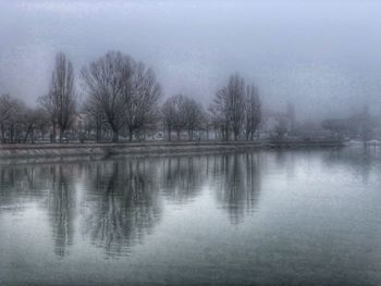 Scenic view of lake against sky during winter