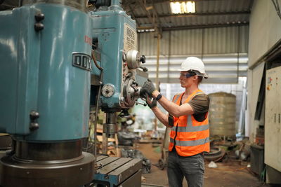 Portrait of male worker standing in the heavy industry manufacturing factory.