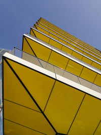 Low angle view of yellow building against clear sky