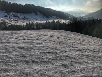 Scenic view of landscape against sky during winter