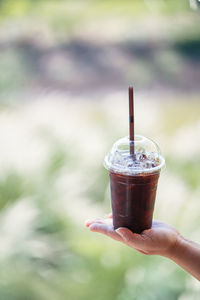 Close-up of hand holding coffee cup