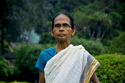 Portrait of woman against plants