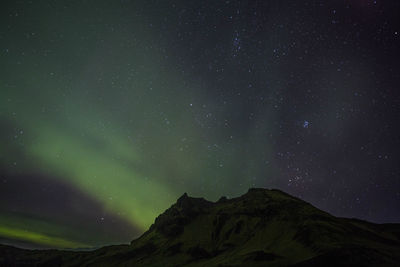 Low angle view of mountain against sky at night